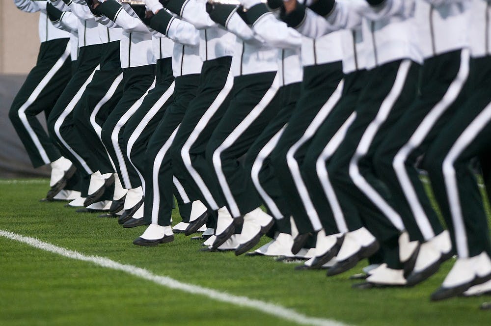 	<p>The Spartan Marching Band marches on the field before the game on Aug. 30, 2013, at Spartan Stadium. The Spartans defeated the Broncos, 26-13. Katie Stiefel/The State News</p>