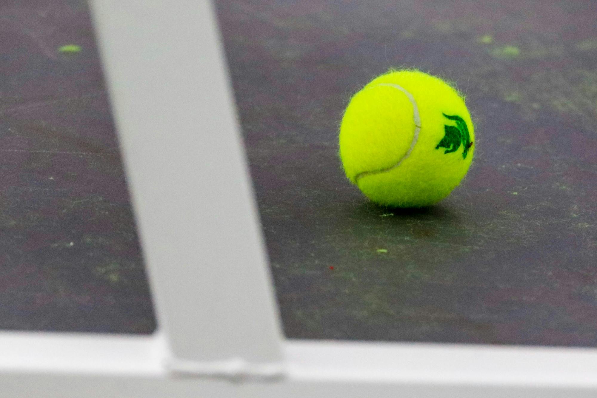 A tennis ball sits under a bench during the games against Niagara at the MSU Tennis Center on Jan. 25, 2020. The Spartans defeated the Purple Eagles, 7-0