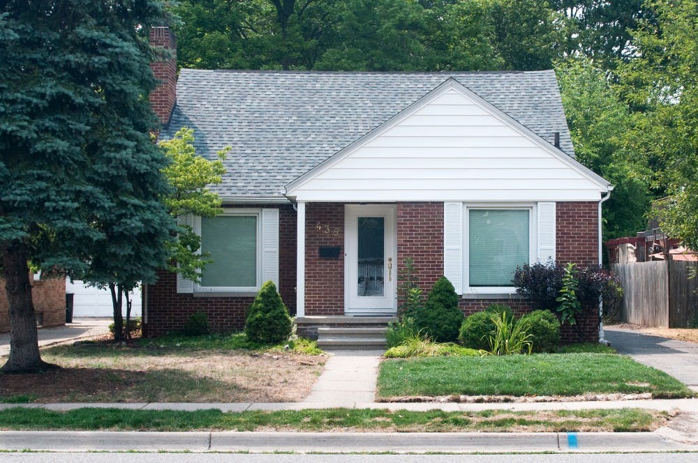 A house with a two-toned grass lawn sits on Bailey St. in East Lansing on Monday, July 16, 2012. This summer, the Lansing area has been experiencing an unusually dry season. Samantha Radecki/The State News