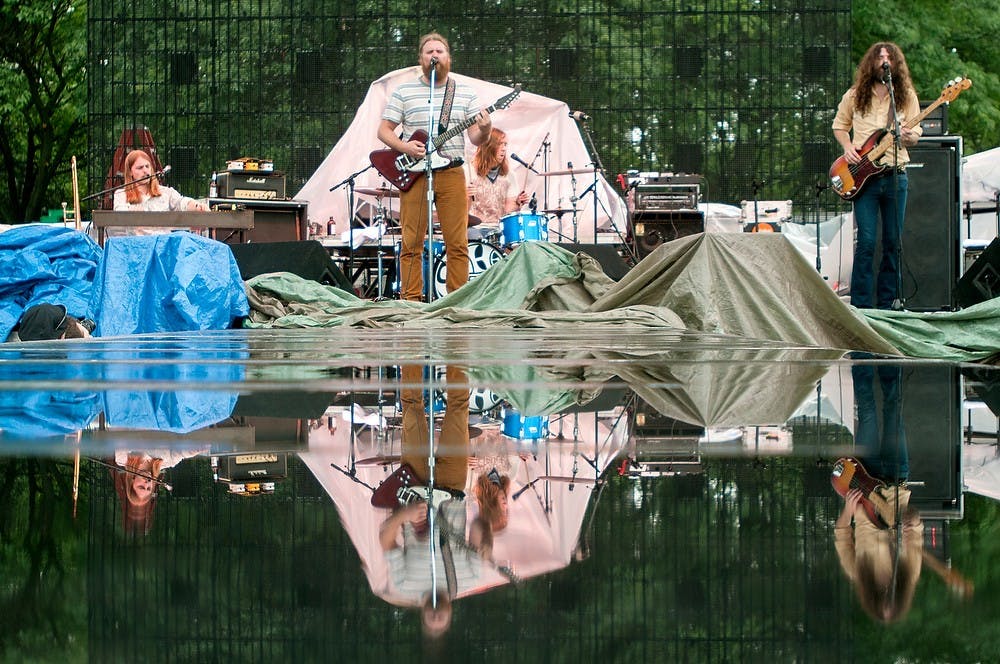 	<p>The Sheepdogs perform after a rain July 9, 2013 at the Common Ground Music Festival at Adado Riverfront Park. Weston Brooks/The State News</p>