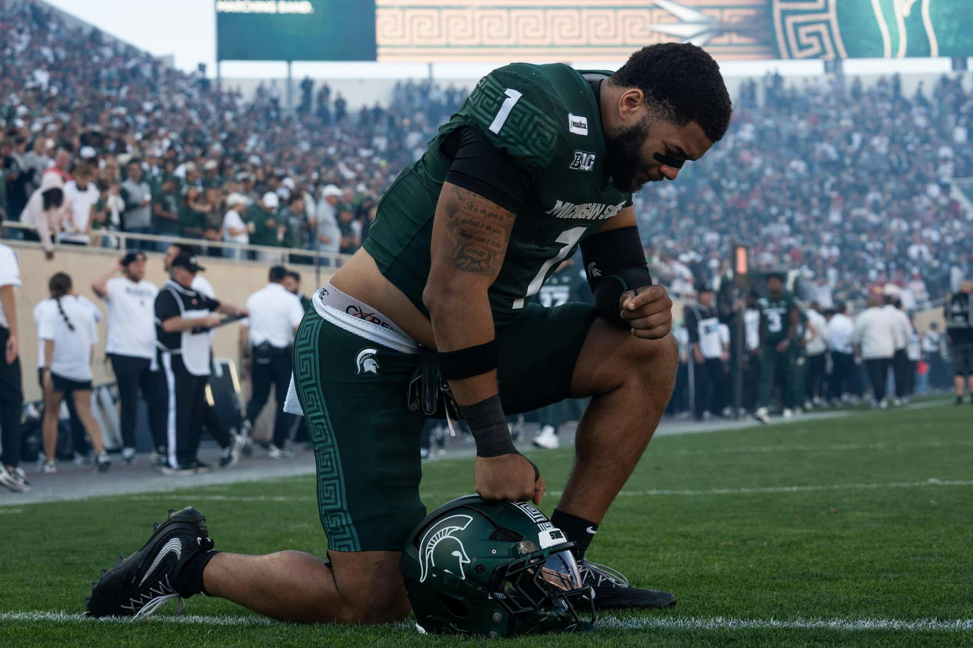 <p>Michigan State senior edge rusher Kenny Soares Jr. takes a knee before the Spartans’ game against Nebraska at Spartan Stadium in East Lansing, Mich., on Saturday, Sept. 26, 2026.</p>