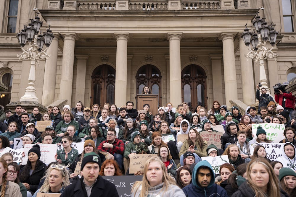 <p>Students surround psychology junior Maya Manuel as she spoke at the Michigan Capitol Building on Wednesday, Feb. 15, 2023 - two days after the mass shooting in Michigan State University’s north campus. Students detailed their experiences and speakers called for legislative action to prevent future tragedy.</p>