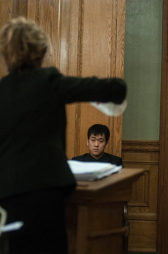 <p>Ingham County assistant prosecutor Kimberly Hesse holds up a plastic water pitcher while cross-examining MSU alumnus Meng Long Li Jan. 30 at 30th Circuit Court in the Ingham County Courthouse, 315 S. Jefferson St, Mason, Michigan. The water pitcher is a major piece of evidence involved in crimes that were committed Jan. 31, 2014, at Limit Pool &amp; Karaoke Club, 2800 E. Grand River Ave. and had been used to repeatedly beat the student who was attacked that evening. Allyson Telgenhof/The State News.</p>