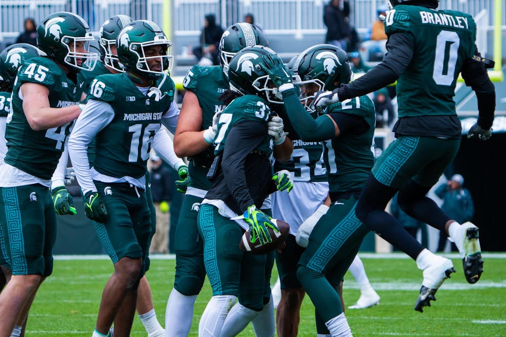 <p>Redshirt senior defensive back Khary Crump (37) is swarmed by teammates after completing an interception during MSU football’s 2024 Spring Showcase on April 20, 2024.</p>