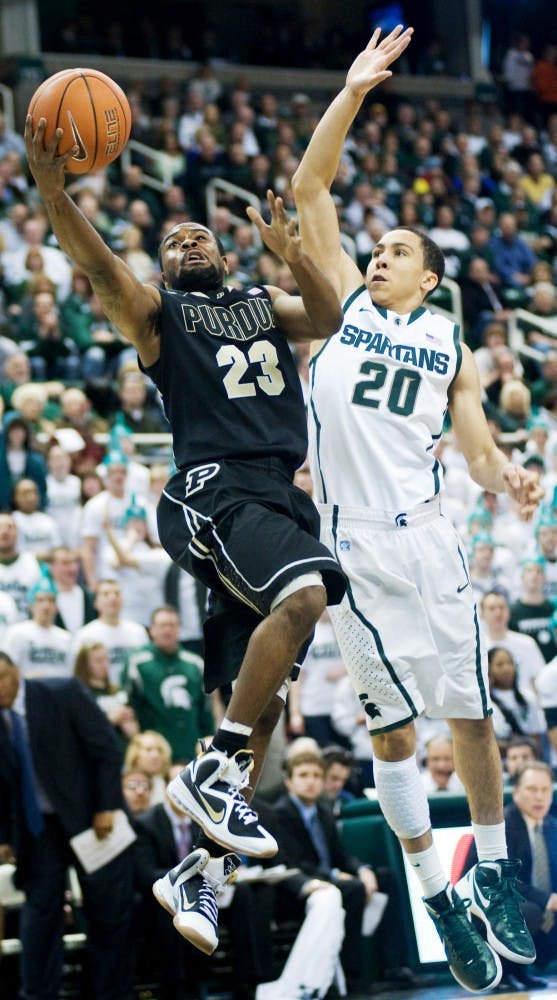 Purdue guard Lewis Jackson goes up for a layup as freshman guard Travis Trice attempts to stop the action from behind. The Spartans defeated the Purdue Boilermakers, 83-58, Saturday afternoon at Breslin center. Justin Wan/The State News