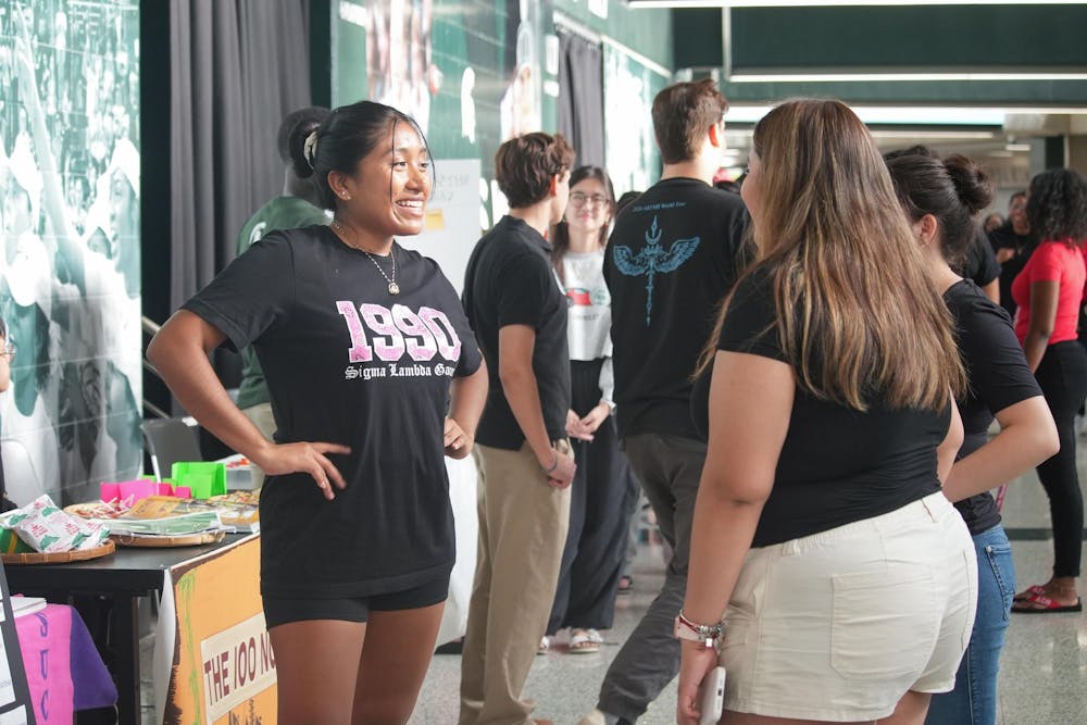 <p>Rosa Cruz Hernandez, the vice president of recruitment for Sigma Lambda Gamma, talks to students at Spartan Remix on Sept. 5th, 2024. Spartan Remix is a student event for multicultural student organizations that helps get their name out to new and prospective students.</p>