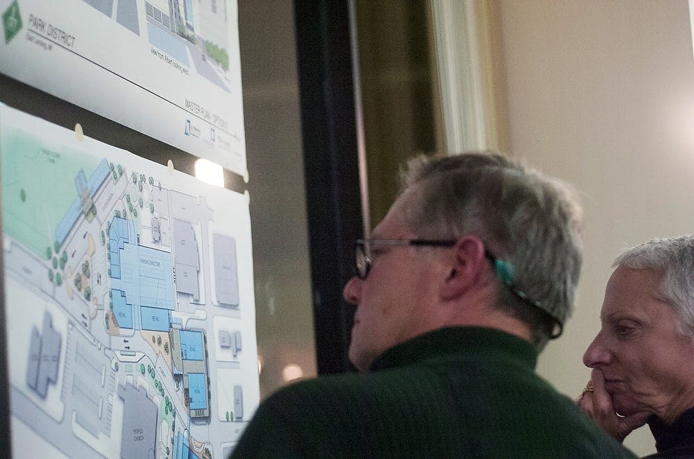 	<p>East Lansing residents Thom Law and Rita Richardson look at possible designs for the East Lansing Park District project at the third charrette Nov. 14, 2013, at The East Lansing Marriott at University Place. Potential features include a farmer&#8217;s market, a parking garage and a park. Micaela Colonna/ The State News</p>