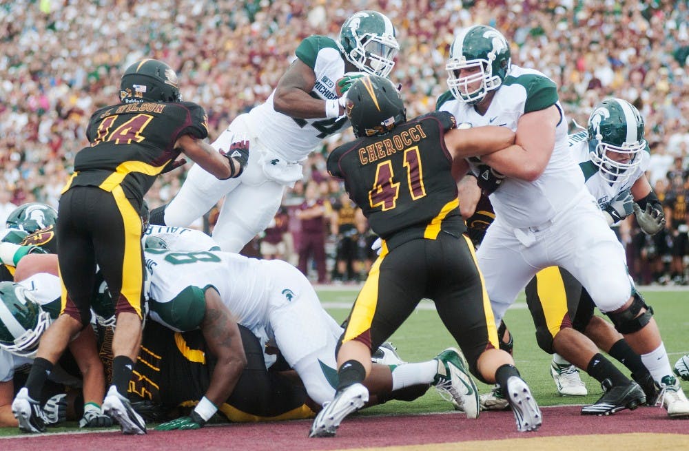 Junior running back Le'Veon Bell takes a leap for a touchdown. The Spartans defeated the Chippewas, 41-7, on Saturday, Sept. 8, 2012, at Kelly/Shorts Stadium in Mount Pleasant, Mich. Justin Wan/The State News