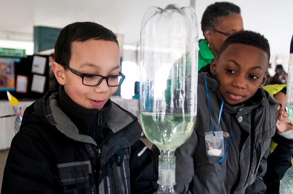 	<p>Haslett, Mich. resident Ederick Plantegenest, 9, looks at a water tornado at the <span class="caps">MSU</span> Science Festival on Saturday, April 13, 2013, under the Lansing State Journal Expo Tent in the lawn area between Agriculture Hall and North Kedzie Hall. The festival runs until April 21. Katie Stiefel/The State News</p>