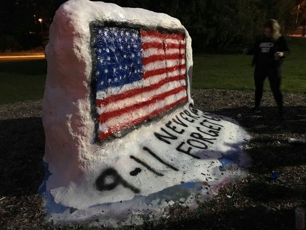 <p>Members of the MSU College Democrats, the MSU College Republicans and other groups on campus paint the MSU Rock for an annual memorial to remember those lost in the 9/11 attacks.&nbsp;</p>