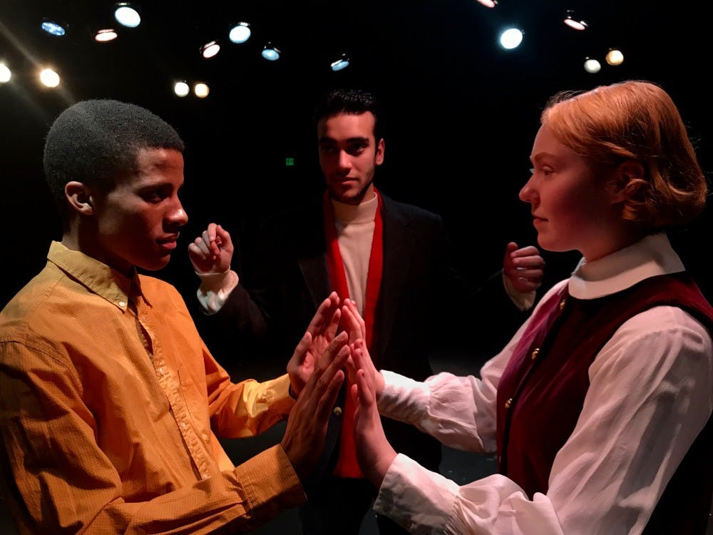 <p>Actors in "Thus With a Kiss I Die" portray Romeo and Juliet in the fictitious Jekyll University's production of Shakespeare's play. Set in the American south in 1958, the interracial casting creates tension at the university and mayhem ensues. (Left to right) Evan Phillips, Raied Jawhari and Jamie Lien (Photo by Teriah Fleming)</p>