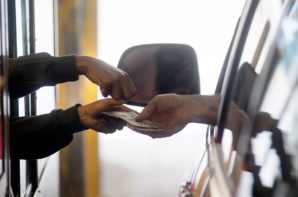 <p> A person pays for their parking bill at the City of East Lansing parking garage near 181 Division Street on June 30th, 2015. Joshua Abraham/ The State News</p>