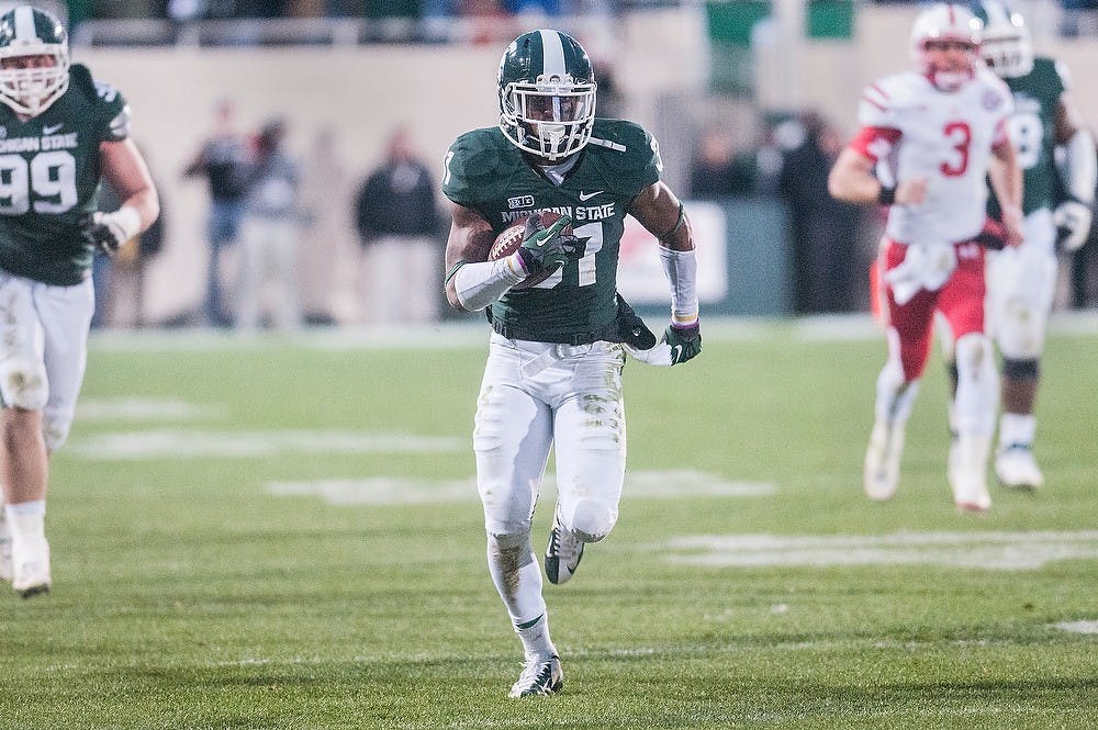 	<p>Junior cornerback Darqueze Dennard runs for the end zone after making an interception Nov. 3, 2012, at Spartan Stadium. Despite returning the interception, a penalty on the play would bring the ball back 90 yards. Adam Toolin/The State News</p>