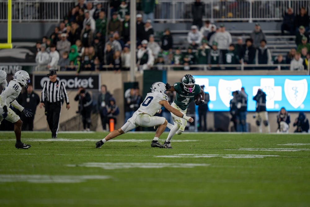 Michigan State running back Elijah Tau-Tolliver (#4) powers forward at Spartan Stadium in East Lansing, Mich., on Saturday, Nov. 16, 2025.