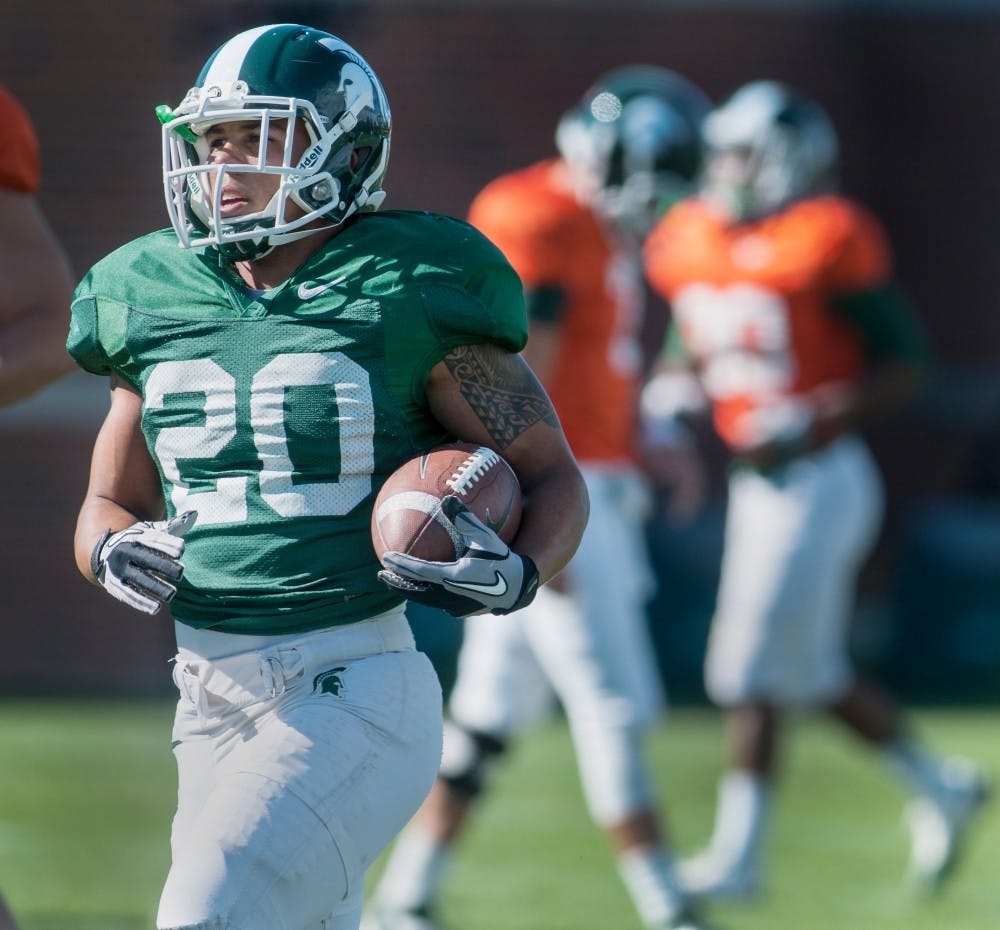 Sophomore running back Nick Hill runs a drill Tuesday, Sept. 18, 2012 at the Duffy Daugherty Football Building practice field. After a loss to Notre Dame last Saturday, MSU looks to bounce back with a win this weekend at home against Eastern Michigan. Adam Toolin/The State News