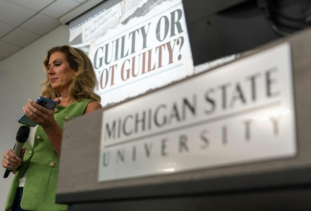<p>Guest speaker Alysia Sofios holds up a microphone while on the phone with Linda Stermer, who was recently found guilty of premeditated, first-degree murder, while talking with students at Brody Hall in East Lansing, Mich., on Wednesday, Sept. 30, 2026.</p>