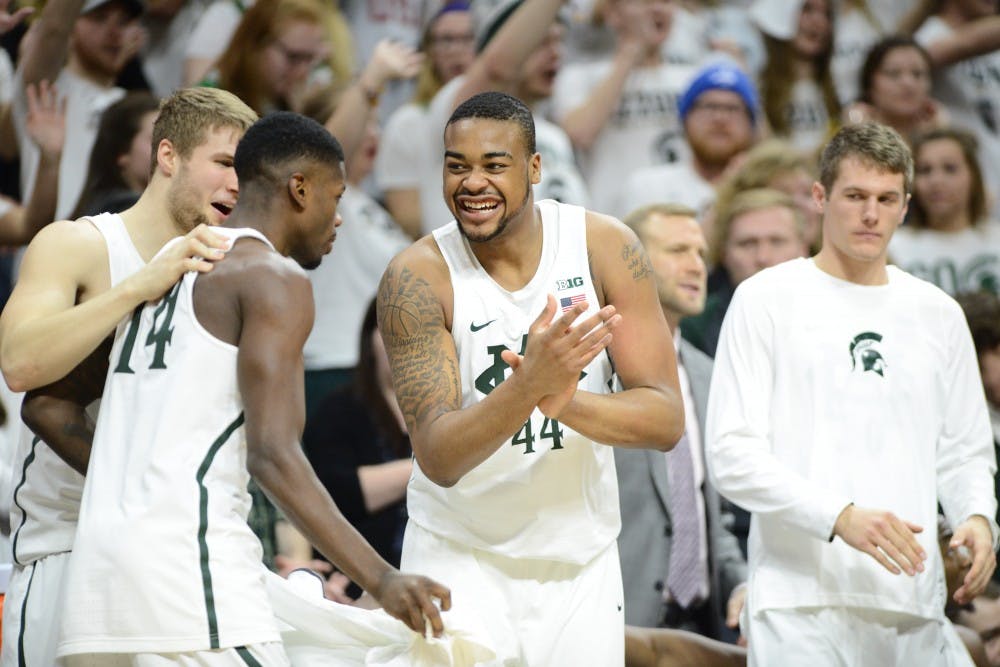 Freshman forward Nick Ward (44) reacts as senior guard Eron Harris (14) gets subbed in during the second half of men's basketball game against the University of Wisconsin on Feb. 26, 2017 at Breslin Center. The Spartans defeated the Badgers, 84-74.