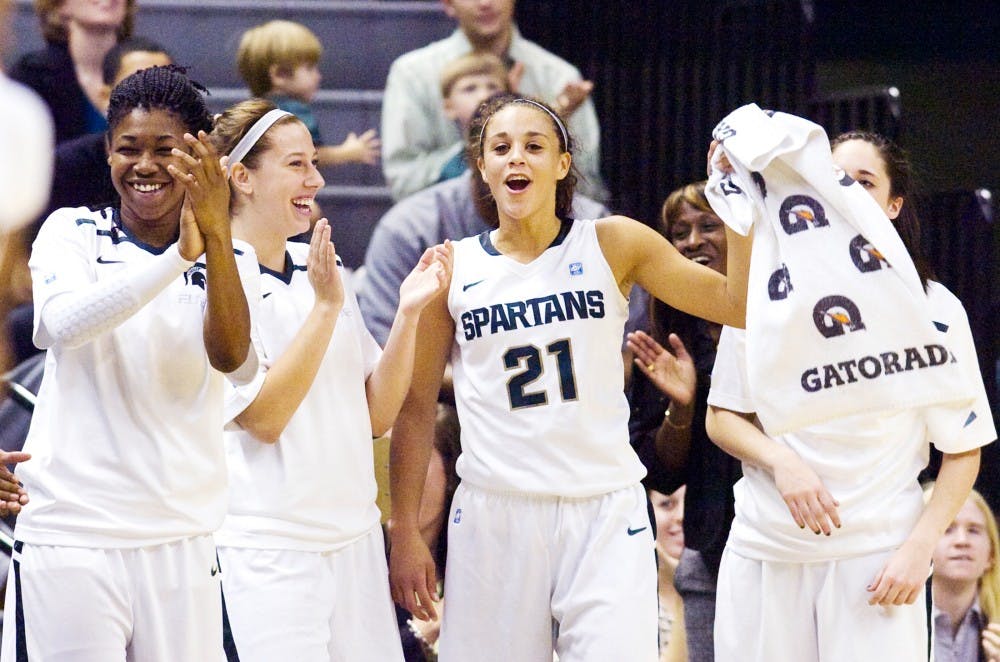 Sophomore guard Klarissa Bell celebrates with her teammates Thursday night at Breslin Center. The Spartans defeated the Lakers 94-31. Matt Radick/The State News