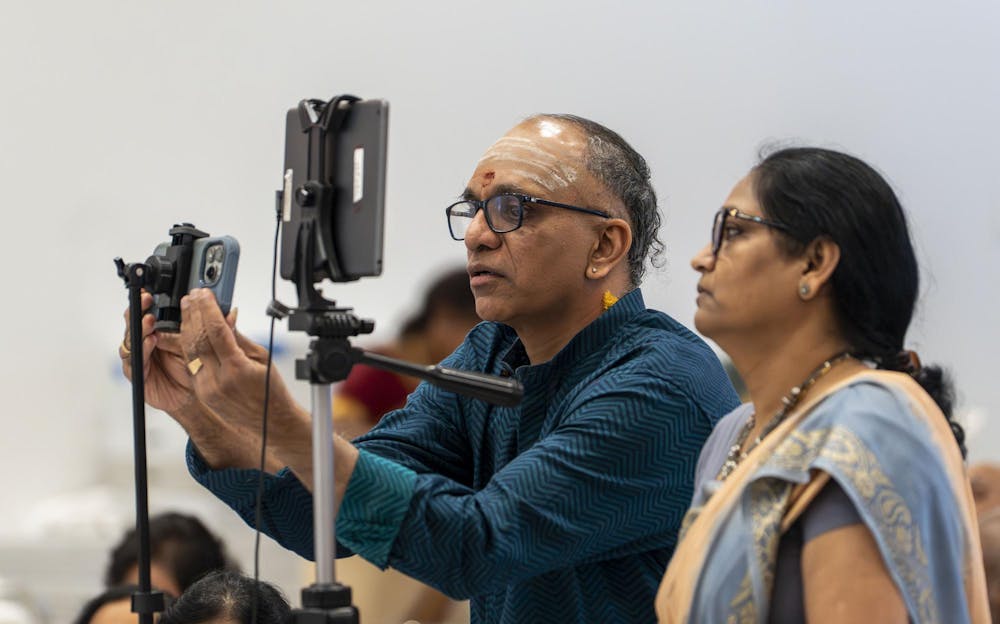 Abhinav Anand’s father Anand Yegnan and one of his aunties set up tripods to record Abhinav’s dance for the Shivaratri festival at the Sri Sharadamba Temple in Farmington Hills, Mich., on March 8, 2026. “I'm so fortunate,” Abhinav said. “I have such supportive and loving parents, and I have such a good friend circle that supports my art constantly.”