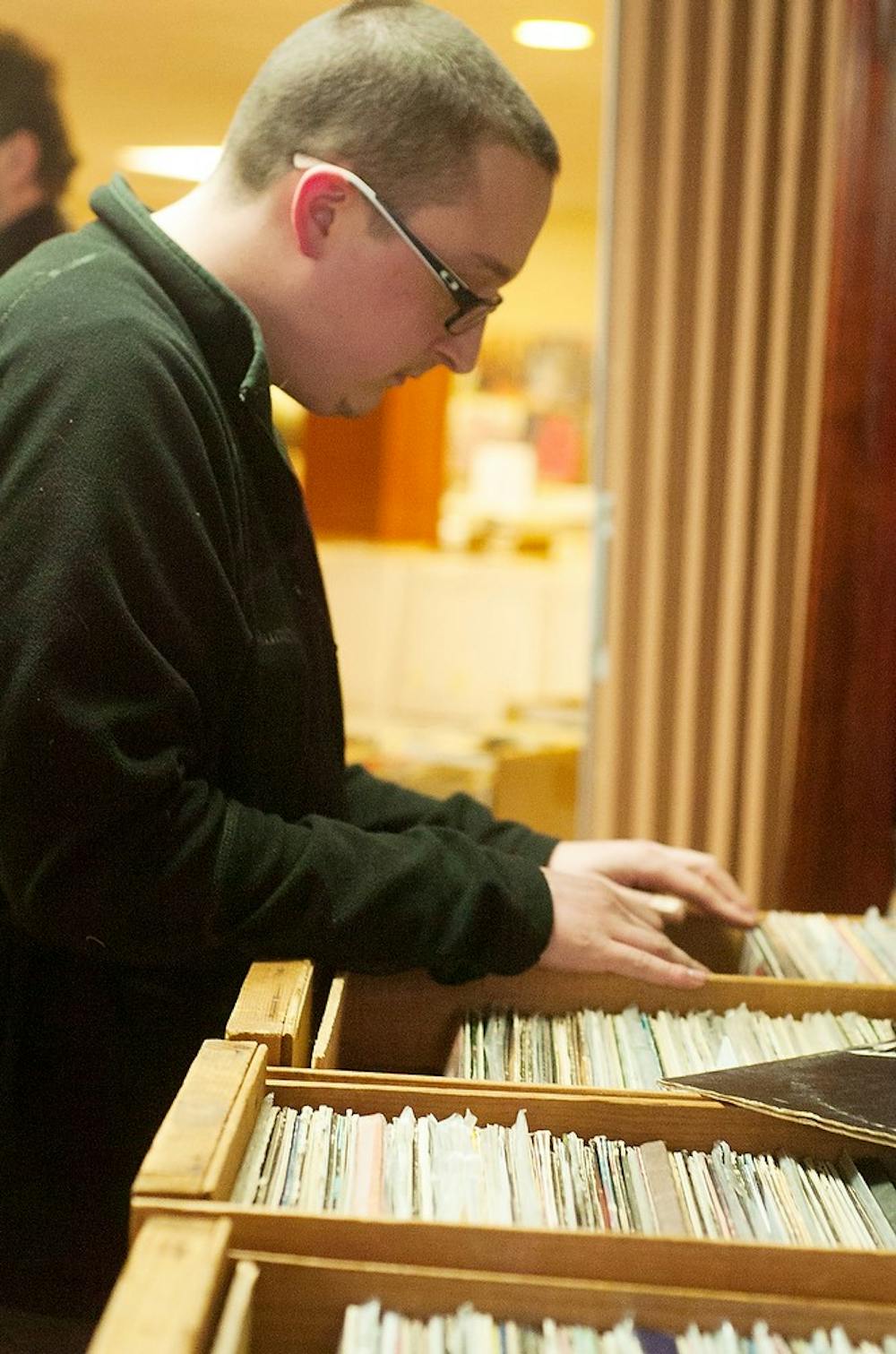 	<p>Lansing resident Brian Jupin looks through records during Lansing record and CD show on Nov. 16, 2013. The show included vinyl albums, 45&#8217;s, posters and <span class="caps">DVD</span>&#8217;s of various artists. Micaela Colonna/The State News</p>