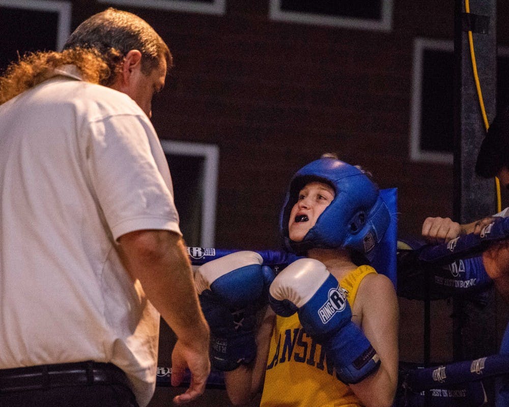 Van Wirtz shows his mouthguard to the referee before his fight in the 70 lb Bantam Novice Division at the Capital City Fight Night at the RA1 Basketball Range Nov. 2, 2018. Wirtz fought for Crown Boxing.