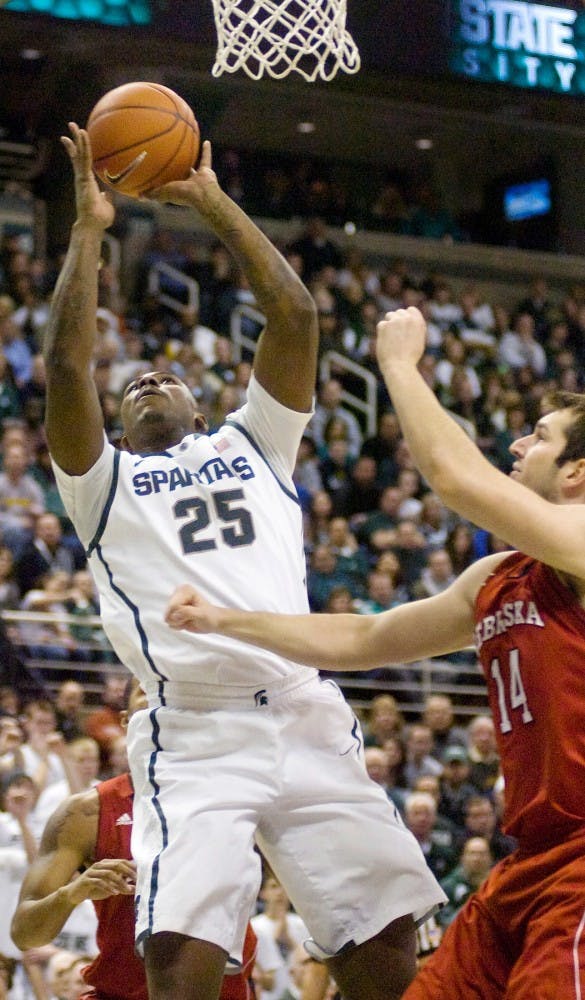 Junior center Derrick Nix goes for a shot over Nebraska center Christopher Niemann Saturday night at Breslin Center. The Michigan State Spartans beat the Nebraska Cornhuskers 62-34. Derek Berggren/The State News