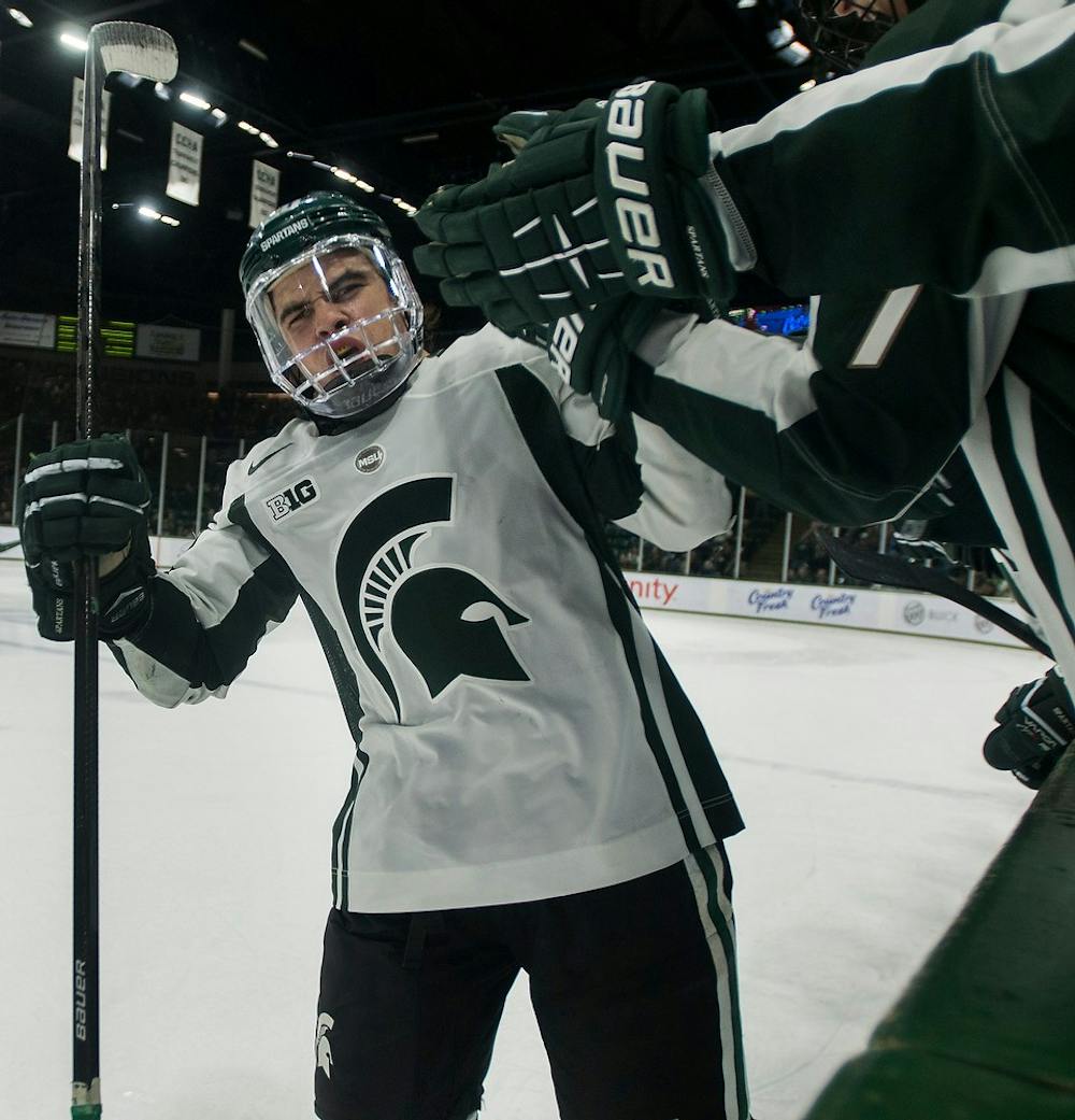 	<p>Sophomore forward Michael Ferrantino bumps gloves with teammates after a shootout goal during the game against Minnesota on Dec. 6, 2013, at Munn Ice Arena. The Spartans tied the game with the Golden Gophers, 2-2, but won the shootout. Danyelle Morrow/The State News</p>