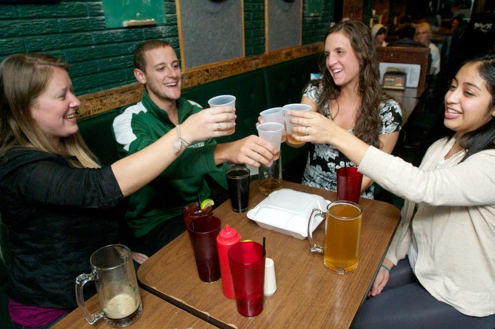 	<p>From left, Chicago resident Britt Huges, packaging senior Douglas Woelmer, Lansing resident Kate Wilson and East Lansing resident Stormie Perez prepare to take a fireball shot. Crunchy&#8217;s is among a group of E.L. businesses that have adapted to a changing landscape. Natalie Kolb/The State News</p>