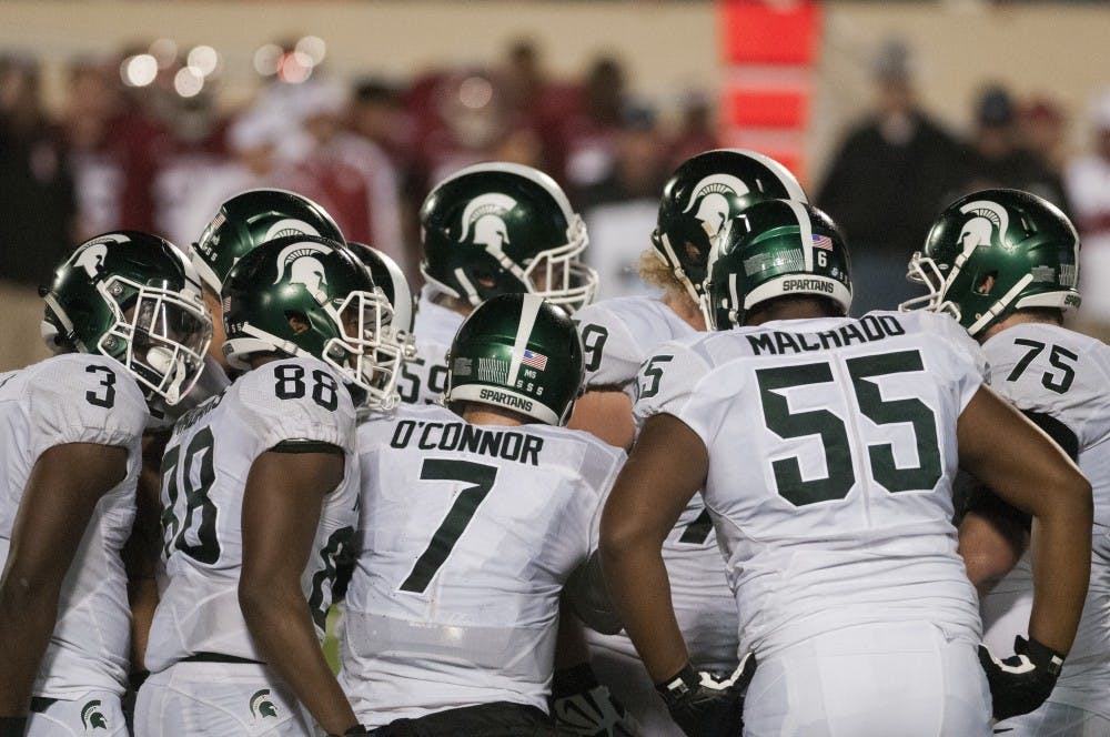 The Spartans huddle on the field after the fourth quarter of the game against Indiana on Oct. 1, 2016 at Memorial Stadium in Bloomington, Ind. The Spartans were defeated by the Hoosiers in overtime, 24-21.