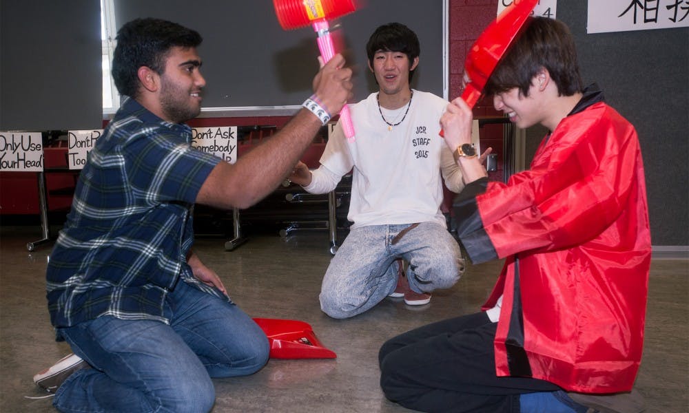 From left to right, business freshman Pavan Sampath, ELC English student Kota Oku, and ELC English student Kiichi Kondo play a game during the Japanese Cultural Reception on Nov. 15, 2015 in Holden Hall. International students from Hosei University in Japan hosted this event to help educate MSU students on Japanese culture. 