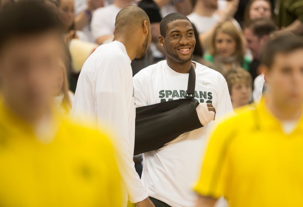 	<p>Senior center Adreian Payne, left, talks to junior forward/guard Branden Dawson before the game against Michigan on Jan. 25, 2014, at Breslin Center. The Spartans lost to the Wolverines, 80-75. Julia Nagy/The State News</p>