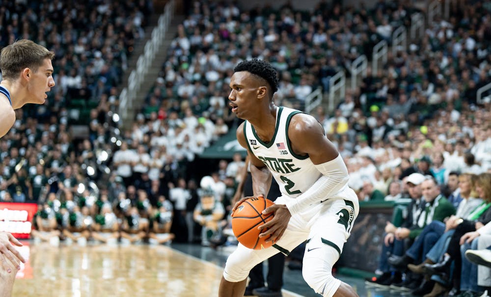 Senior guard Tyson Walker (2) debates who to pass the ball to during a game against Villanova at the Breslin Center on Nov. 18, 2022. The Spartans defeated the Wildcats 73-71. 