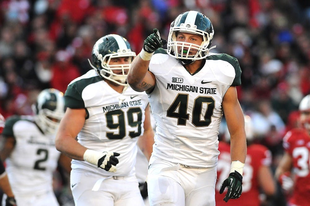 Junior linebacker Max Bullough points toward the direction of Michigan State fans after sacking Wisconsin quarterback Danny O'Brien. Michigan State defeated Wisconsin in overtime, 16-13, on Saturday afternoon, Oct. 27, 2012, at Camp Randall Stadium in Madison, Wisc. Justin Wan/The State News