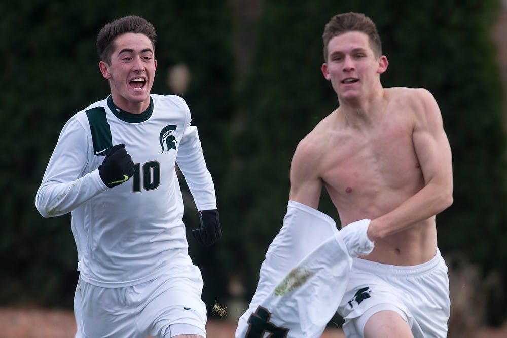 	<p>Junior forward Tim Kreutz and sophomore midfielder Jay Chapman, 10, run towards the Red Cedar Rowdies after Kreutz scored the game winning goal Nov. 24, 2013, during the second round of the <span class="caps">NCAA</span> tournament at DeMartin Stadium at Old College Field. The Spartans defeated the Cardinals 1-0 in double overtime. Julia Nagy/The State News</p>