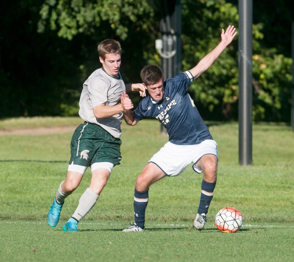 <p>Freshman defender Connor Corrigan and Notre Dame midfielder Patrick Hodan fight for the ball during the game on Sept. 22, 2015, at DeMartin Soccer Stadium. The Spartans was defeated by the Fighting Irish 4-0. Joshua Abraham/ The State News</p>