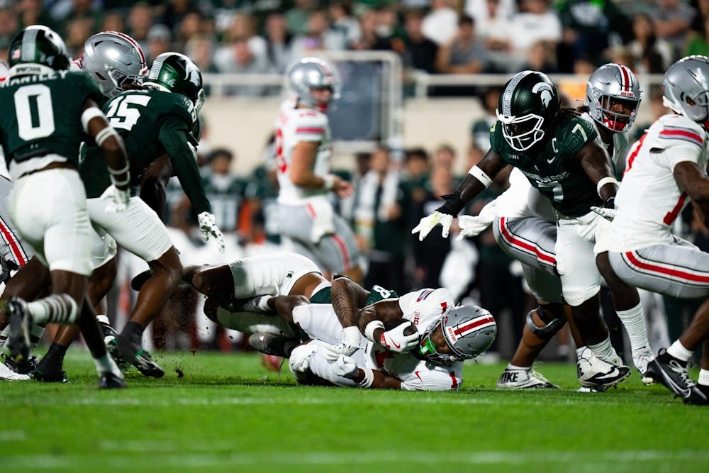 An Ohio State player is tackled by the Michigan State Spartans at Spartan Stadium, Sept. 28, 2024.
