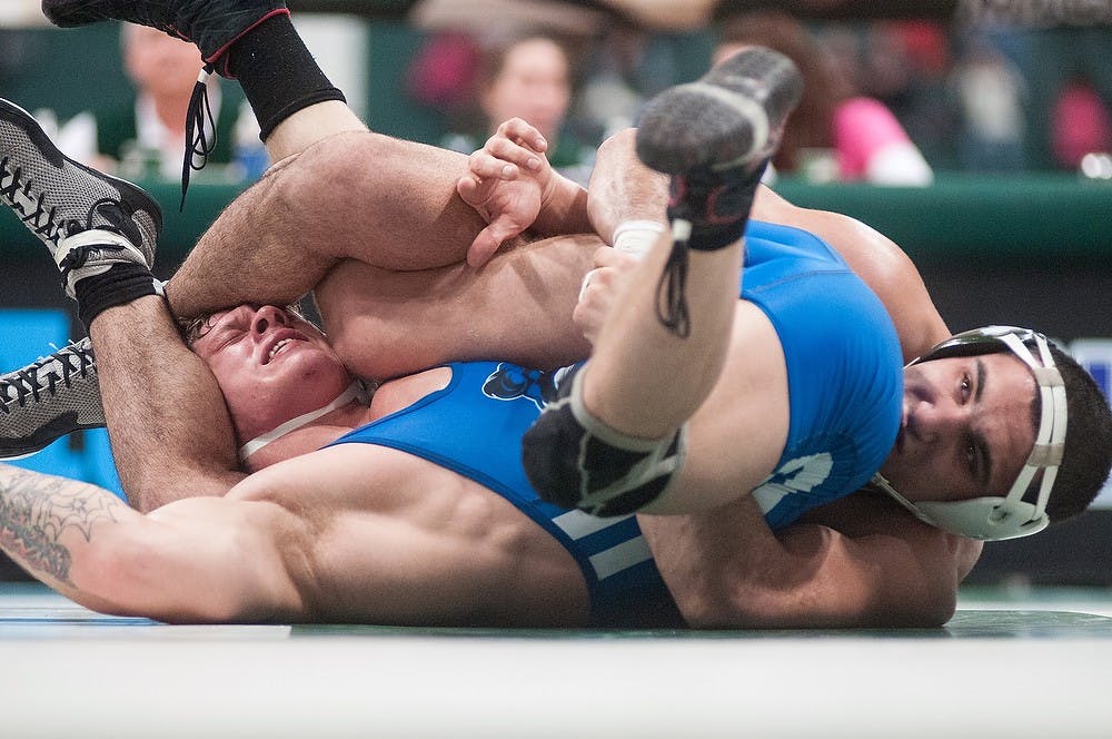 	<p>Sophomore 184-pounder John Rizqallah and Lindsey Wilson&#8217;s Ian Stephens wrestle during a meet Jan. 6, 2013, at Jenison Field House. Rizqallah won 7-3. Julia Nagy/The State News</p>