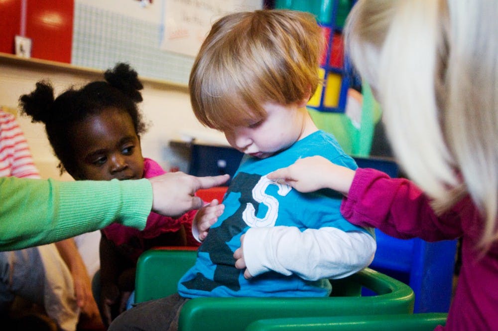 Charlie Waller, 3, and his classmates take a closer look at what he's wearing during class on Nov. 2 at Pinecrest Elementary School, 1811 Pinecrest Drive. Charlie began attending classes in a special education preschool program this fall. Matt Radick/The State News