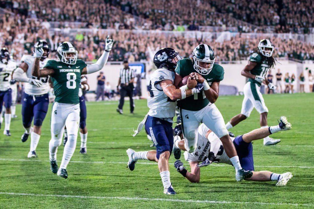 Sophomore running back Connor Heyward (11) rushes for a touchdown during the game against Utah State on Aug. 31 at Spartan Stadium. The Spartans defeated the Aggies, 38-31.