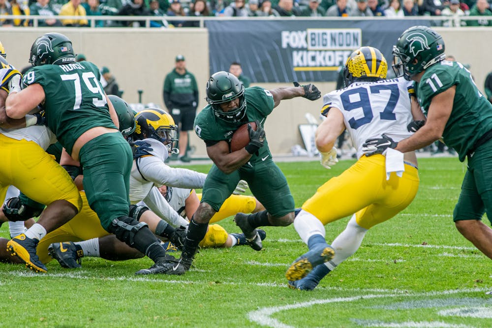 <p>Junior running back Kenneth Walker III finds an opening in the line during the Spartans&#x27; 37-33 win against the Wolverines on Oct. 30, 2021.</p>