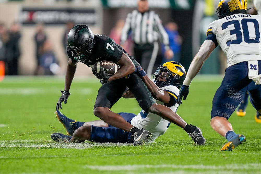 <p>Redshirt freshman wide receiver Antonio Gates Jr. (7) being tackled during a game against University of Michigan at Spartan Stadium on Oct. 21, 2023. The Spartans would end the game with only 133 total receiving yards.</p>