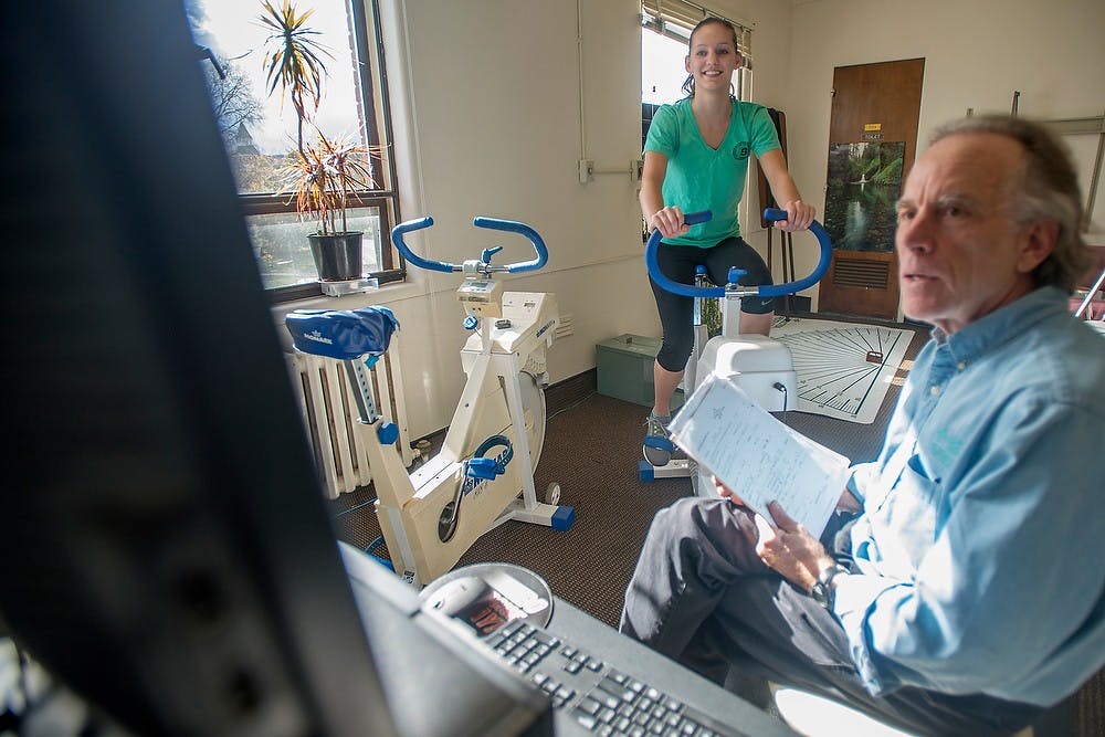 	<p><span class="caps">LIFE</span>:Rx program manager Jonathan Kermiet tests genomics and molecular genetics senior Nikki Pawloske&#8217;s fitness during a <span class="caps">LIFE</span>:Rx appointment on Thursday at the Olin Health Center. As Pawloske continued to cycle, the computer increased the resistance. Julia Nagy/The State News</p>