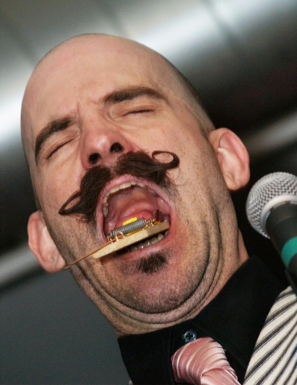 Donny Vomit, performing as "Talker" of the Pretty Things Peep Show, entertains the audience as he snaps a real mouse trap on his tongue in this photo dated Feb. 27, 2011.