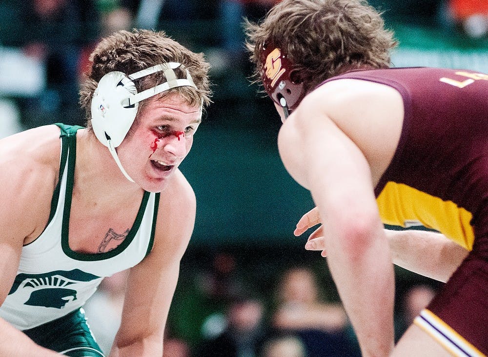 	<p>Sophomore 197-pounder Luke Jones stares down Central Michigan&#8217;s Jackson Lewis on Feb. 22, 2013, at Jenison Field House. Jones defeated Lewis 10-1. Adam Toolin/The State News</p>