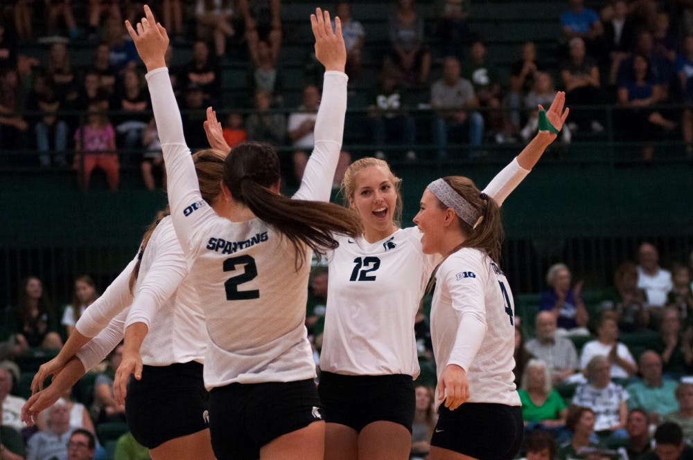 The volleyball team cheers after scoring a point during the volleyball game against Notre Dame on Sept. 16, 2016 at Jenison Field House. The Spartans defeated the Fighting Irish, 3-0.