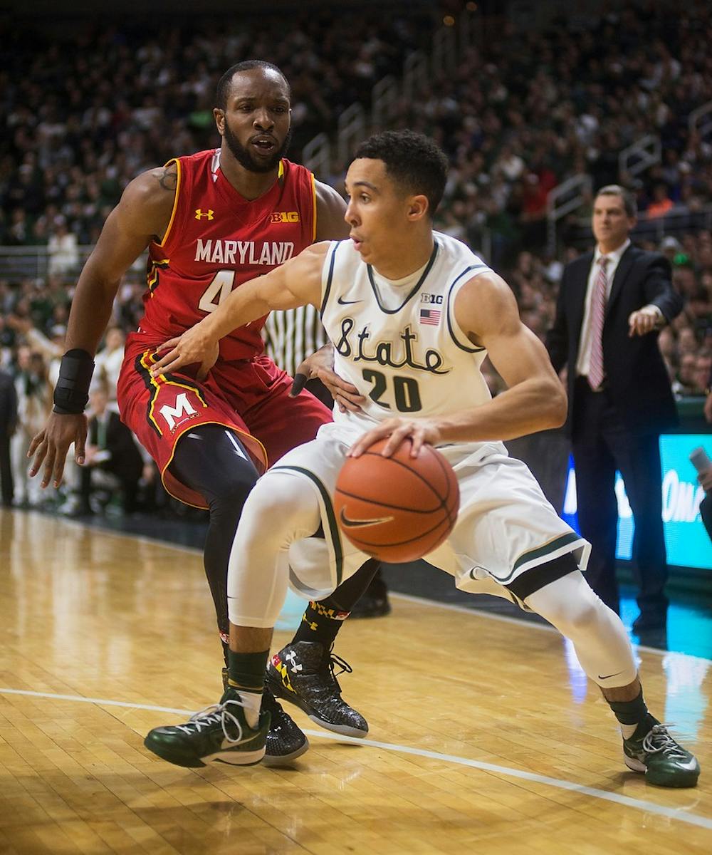 <p>Senior guard Travis Trice is defended by Maryland guard/forward Dez Wells on Dec. 30, 2014, at Breslin Center. The Spartans were defeated by the Terrapins, 68-66 in double overtime. Danyelle Morrow/The State News</p>