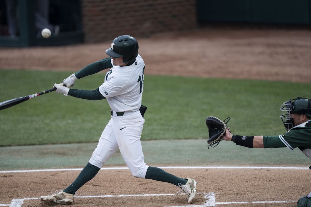 <p>Sophomore infielder Mitch Jebb (14) hits a ball at the game against Eastern Michigan at the McLane Baseball Stadium on April 20, 2022.</p>