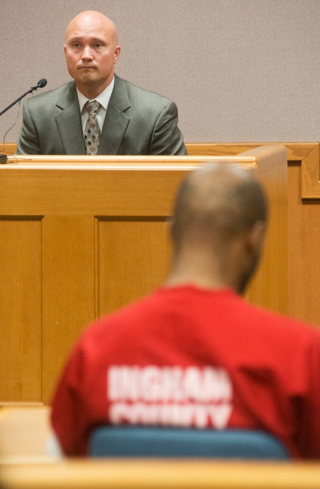 <p>Detective Brad St. Aubin, with Lansing police, testifies during Ricard Taylor's preliminary exam Aug. 29, 2014, at the 54B District Court in East Lansing. Taylor faces seven felony charges, including two counts of open murder in regards to the shooting deaths of Rite Aid pharmacist Michael Addo and Lansing resident Jordan Rogers. Julia Nagy/The State News</p>