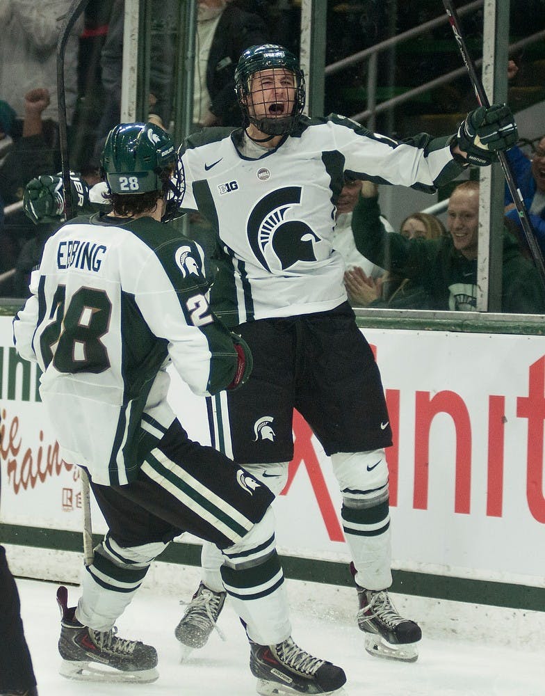 <p>Freshman forward Mackenzie MacEachern celebrates his goal with freshman forward Thomas Ebbing during the game against Michigan on March 8, 2014, at Munn Ice Arena. The Spartans defeated by the Wolverines, 4-3. Danyelle Morrow/The State News</p>