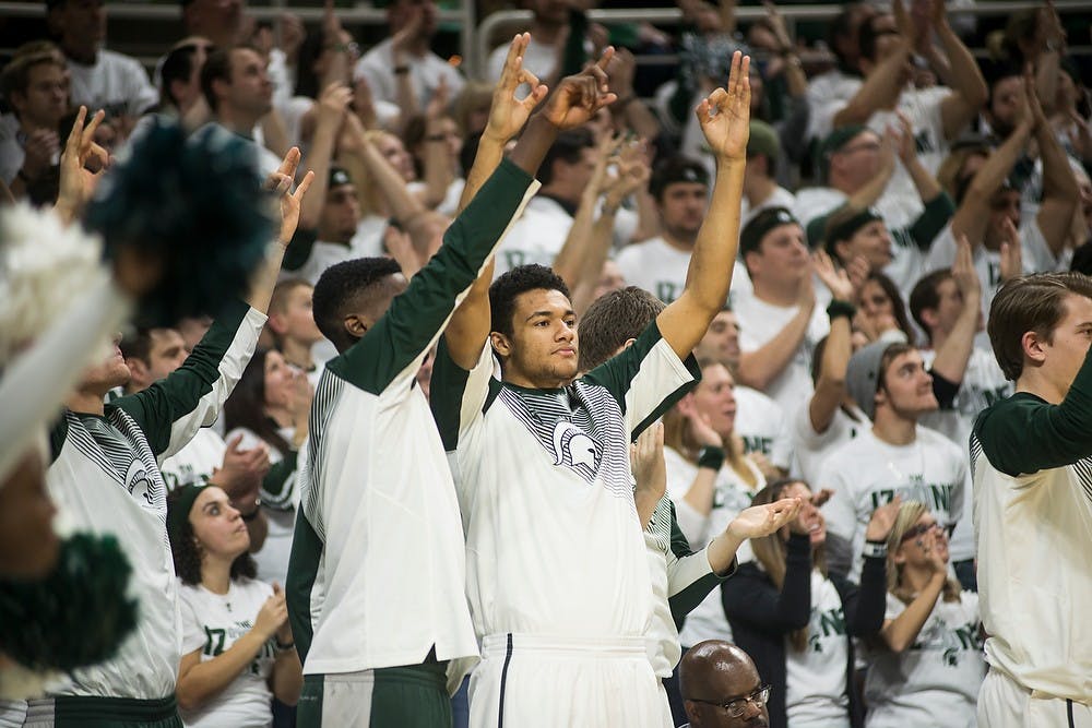 <p>Then freshman forward Kenny Goins, right, cheers for his teammats after a scored basket with junior guard Eron Harris Jan. 5, 2015, during the game against Indiana at Breslin Center. The Spartans defeated the Hoosiers, 70-50. Erin Hampton/The State News</p>